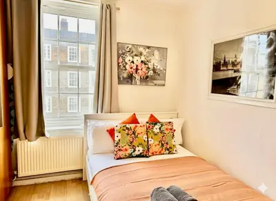 a bedroom with a bed with pillows and a window at Entire 1 bedroom in VAUXHALL Central London Zone 1 in Moffat
