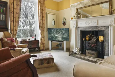 a living room with a fireplace and a television at Seaside ParkView Near Lake District and Marina - Pass the Keys in Whitehaven