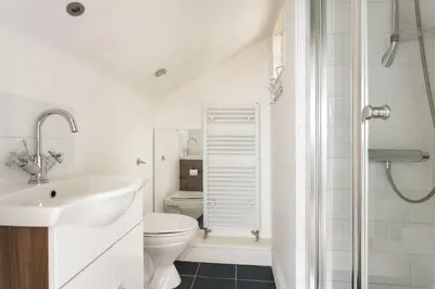 a white bathroom with a toilet and a sink at Seaside ParkView Near Lake District and Marina - Pass the Keys in Whitehaven