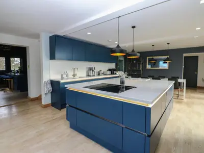 a kitchen with blue cabinets and a kitchen island at Chapel Hill in Carlisle