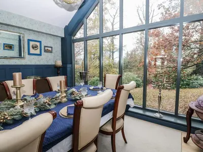 a dining room with a table and a large window at Chapel Hill in Carlisle