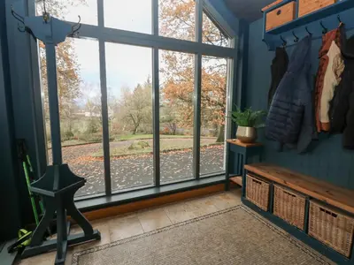 a room with a large window looking out at a yard at Chapel Hill in Carlisle
