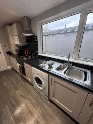a kitchen with a sink and a washing machine at Central Near Hospital 2 Bedroom - Sleeps 4 - Self Check In - Fully Furnished in Carlisle