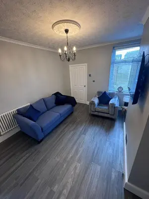 a living room with a blue couch and two chairs at Central Near Hospital 2 Bedroom - Sleeps 4 - Self Check In - Fully Furnished in Carlisle