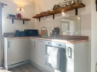 a kitchen with a sink and a washing machine at Lime Tree Barn in Tallentire