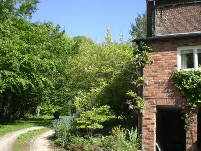 an old brick house with a garden in front of it at Garden flat at Broomfield in Moffat