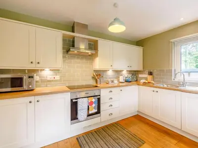 a kitchen with white cabinets and a microwave at 3 Bed in Holmrook oc-sz537 in Beckfoot