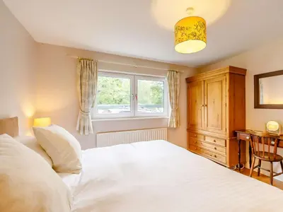 a bedroom with a white bed and a window at 3 Bed in Holmrook oc-sz537 in Beckfoot