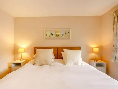 a bedroom with a large white bed with two lamps at 3 Bed in Holmrook oc-sz537 in Beckfoot