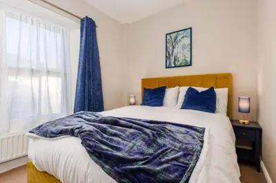 a bedroom with a large bed and a window at South Loft a Modern Apartment in Cockermouth in Cockermouth