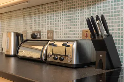 a toaster oven sitting on a counter in a kitchen at South Loft a Modern Apartment in Cockermouth in Cockermouth