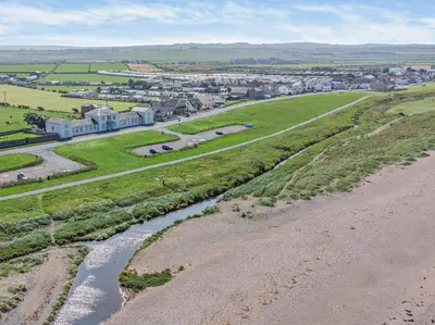 an aerial view of a town with a river at 3 Bed in Maryport oc-sz102 in Allonby