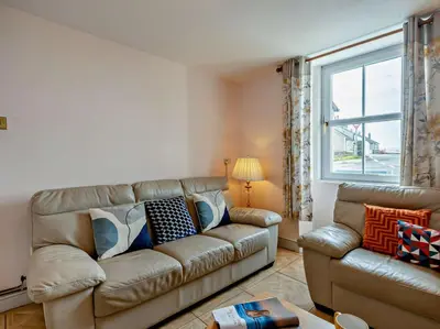 a living room with a couch and a window at 3 Bed in Maryport oc-sz102 in Allonby