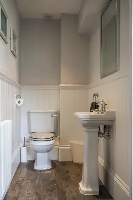 a bathroom with a white toilet and a sink at Old School Mews - Shanklin - Dog Friendly in Moffat
