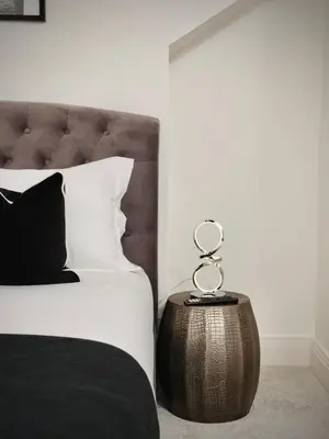 a bedroom with a bed with a metal end table at Premium 4BR I Near Golf Course I Fast Wi-Fi & Free Parking in Moffat
