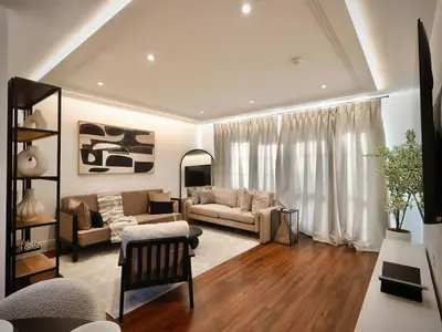 a living room with a couch and a table at Premium 4BR I Near Golf Course I Fast Wi-Fi & Free Parking in Moffat