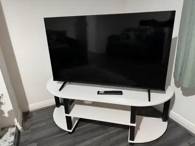 a flat screen tv on a white tv stand at Rowe Terrace Workington in Workington