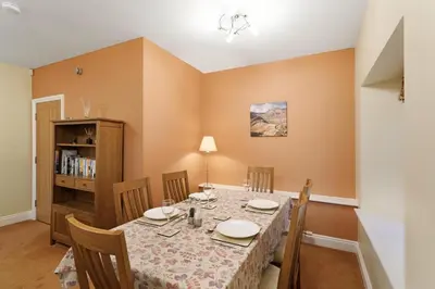 a dining room with a table and chairs at 1 Harney Peak in Portinscale
