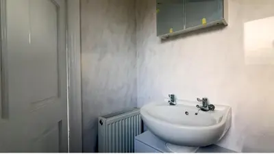 a bathroom with a sink and a mirror at Pecklewell lodge in Ellenborough