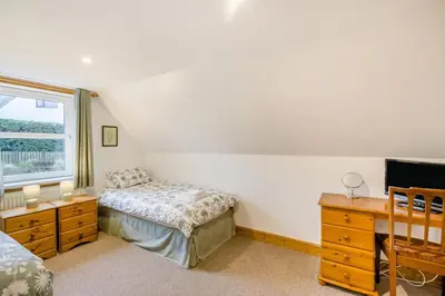 a bedroom with a bed and a dresser and a window at 3 Bed in New Galloway oc-r34387 in New Galloway