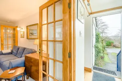 a living room with a couch and a glass door at 3 Bed in New Galloway oc-r34387 in New Galloway