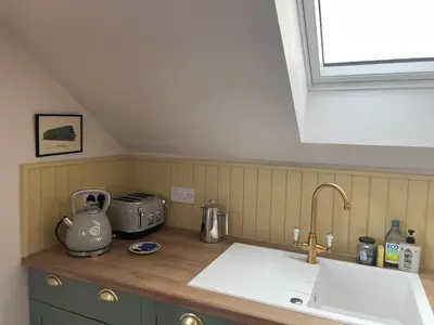 a kitchen counter with a sink and a window at West Coast Whistlestop in Ochiltree
