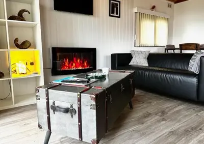 a living room with a couch and a fireplace at Lodge Cabin with Fabulous Views 2 - Farm Stay in Portpatrick