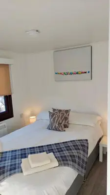 a bedroom with a bed with two towels on it at Lodge Cabin with Fabulous Views 2 - Farm Stay in Portpatrick