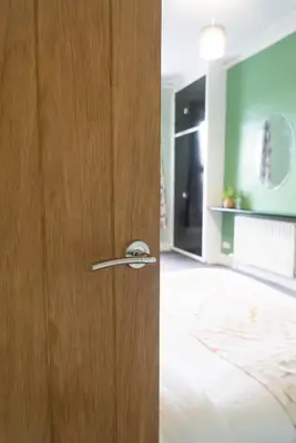 a wooden door with a handle in a room at The Woodrouffee retreat in Carlisle