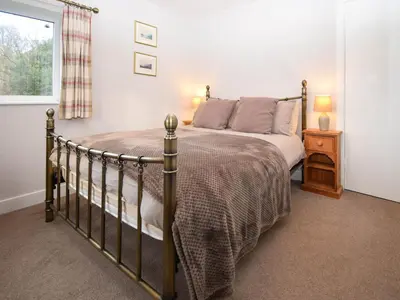 a bedroom with a bed and a window at Derwent View in Applethwaite