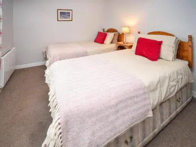 two beds sitting next to each other in a room at Derwent View in Applethwaite