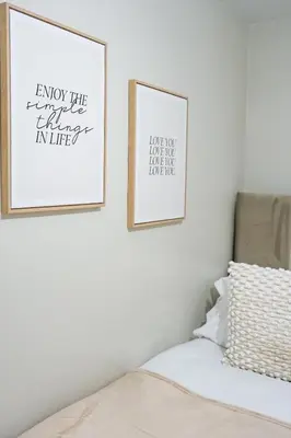 two framed prints on a wall next to a bed at Victory House in Gretna