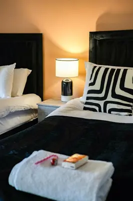 a hotel room with two beds with a tray of food at Victory House in Gretna
