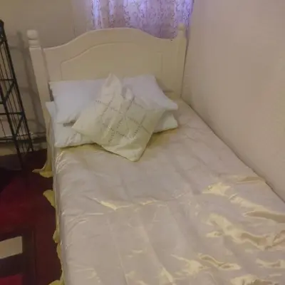 an unmade bed with white sheets and pillows at Room2let in Moffat