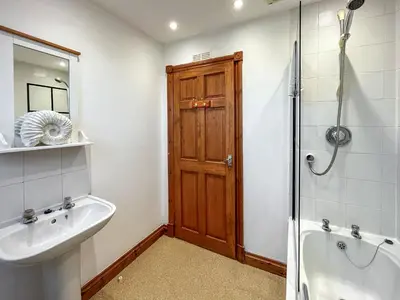 a bathroom with a sink and a shower and a toilet at Graeme-An-Taoiseach Uk50061 in Stranraer