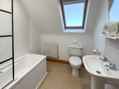 a bathroom with a tub and a toilet and a sink at Graeme-An-Taoiseach Uk50061 in Stranraer