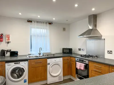 a kitchen with a washing machine and a sink at Graeme-An-Taoiseach Uk50061 in Stranraer