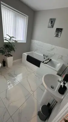 a white bathroom with a sink and a toilet at Ella's Place in Moffat
