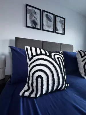 a bed with black and white pillows on it at Oakleigh Way, Carlisle - 2 Bedroom, sleeps 4, Fully furnished in Carlisle