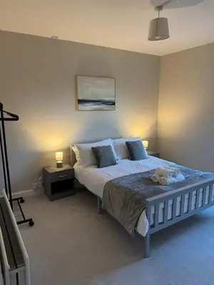a bedroom with a bed with a teddy bear on it at Work-Ready House Near Sellafield in Cleator Moor