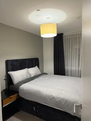 a bedroom with a large bed and a window at Chalk in Moffat
