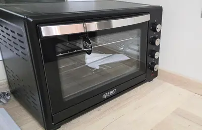 a black toaster oven with its door open at One Old Creamery in Sandhead