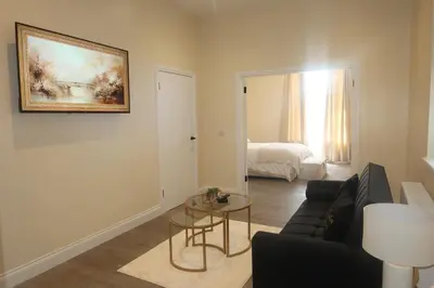 a living room with a couch and a table at Luxury one bedroom apartment in Dumfries