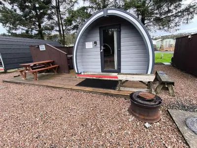 a small dome house with a bench and a table at Barrhill Holiday Park - Glamping in South West Scotland - Duisk in Girvan