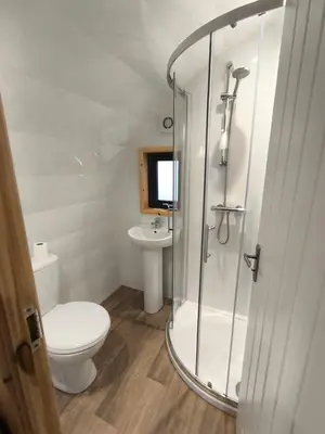 a bathroom with a shower and a toilet and a sink at Barrhill Holiday Park - Glamping in South West Scotland - Duisk in Girvan