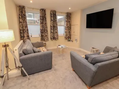 a living room with two couches and a flat screen tv at 20 Lorton Street in Cockermouth