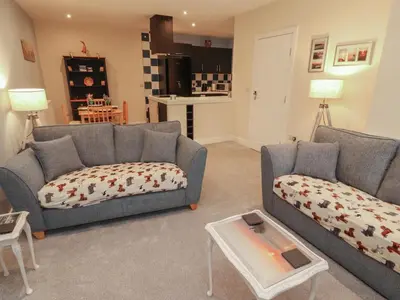 a living room with two couches and a table at 20 Lorton Street in Cockermouth