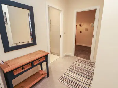 a living room with a mirror and a table at 20 Lorton Street in Cockermouth