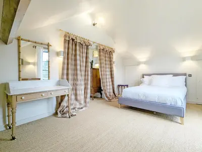 a bedroom with a bed and a desk at The Granary in Moffat