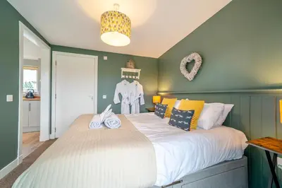 a bedroom with a large bed with towels on it at 1 Bed in Gatehouse Of Fleet oc-t34445 in Gatehouse of Fleet
